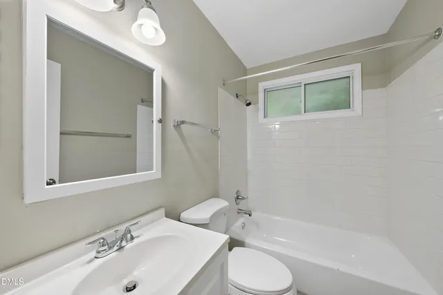 a bathroom with a bathtub shower sink and a toilet