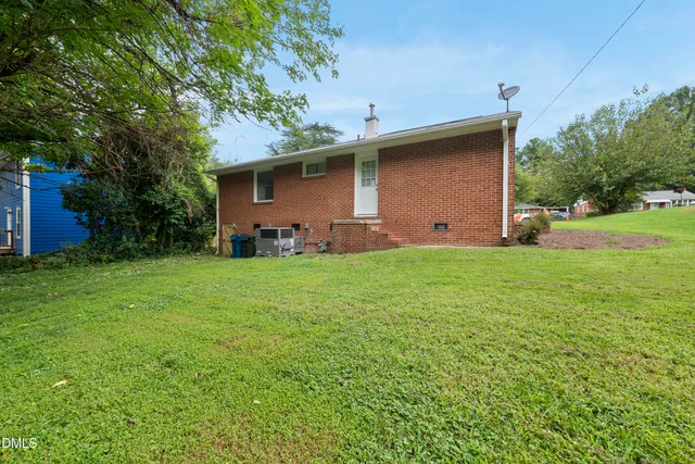 a backyard of a house with table and chairs