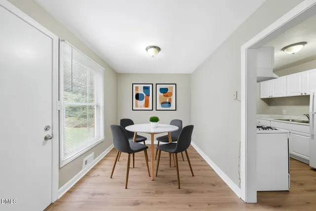 a dining room with furniture and wooden floor