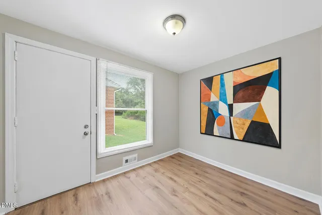 a view of room with window and wooden floor