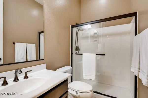 a bathroom with a tub sink and mirror