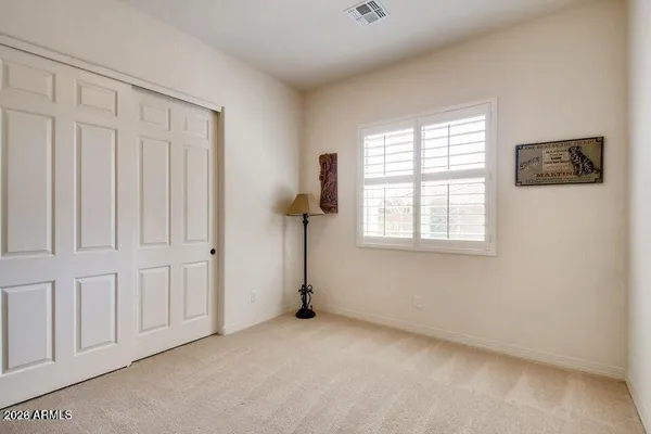 a bedroom with a bed and a closet