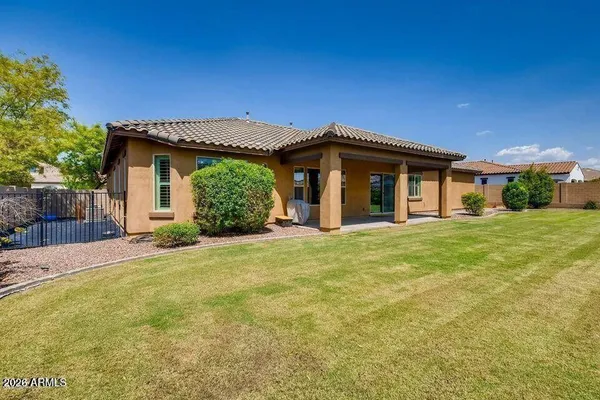 a backyard of a house with yard and outdoor seating