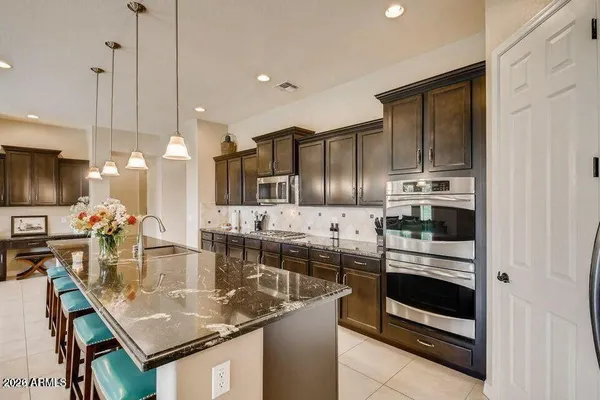 a living room with furniture and a view of kitchen