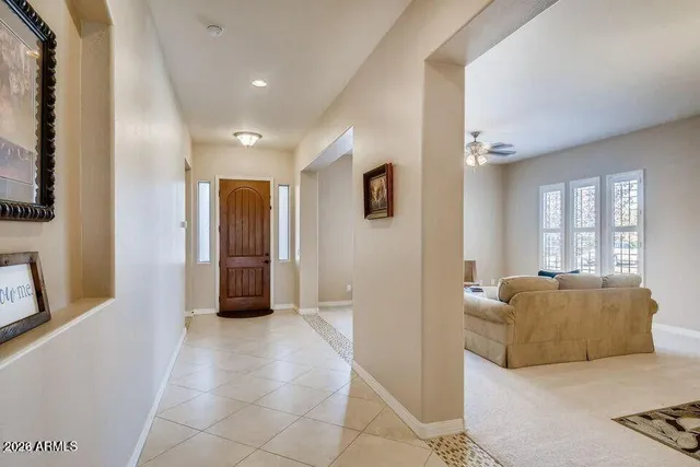a living room with a bed and a chandelier