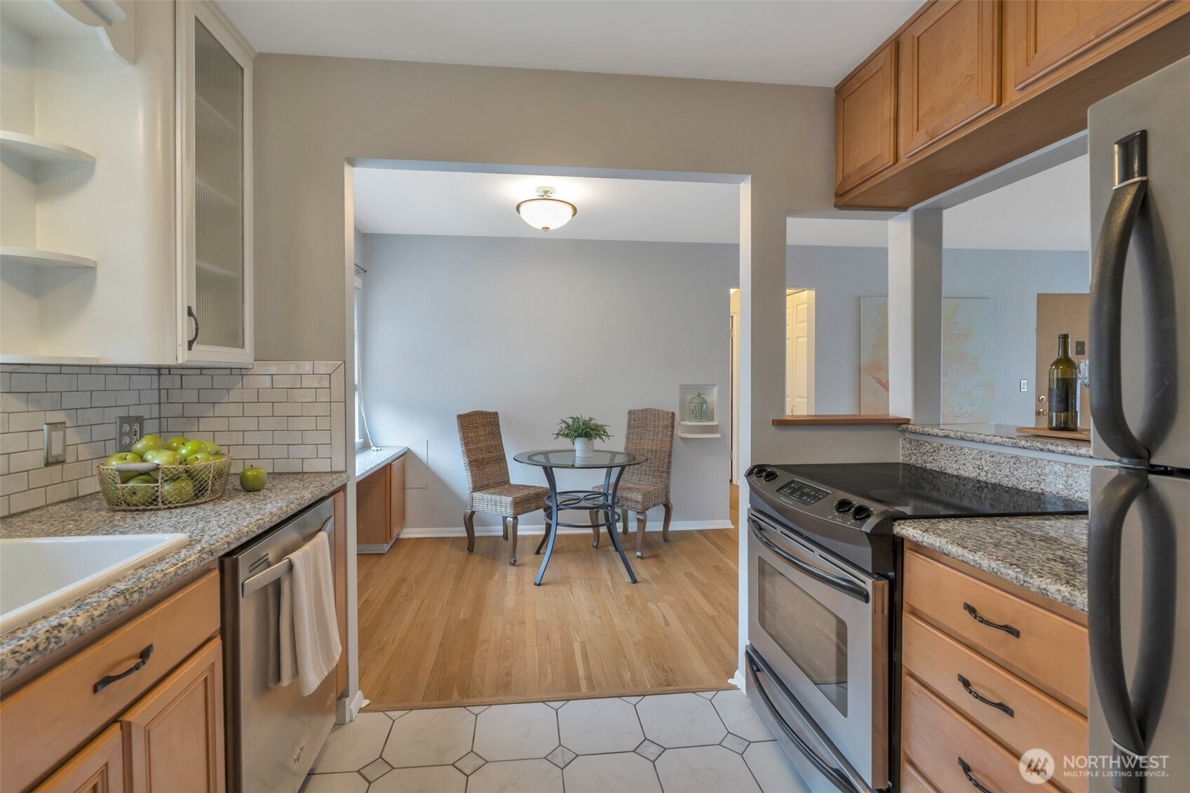 314 North G Street, Unit D2 Tacoma, WA 98403 - Photo 15 of 23 a kitchen with stainless steel appliances granite countertop a stove a sink and a microwave