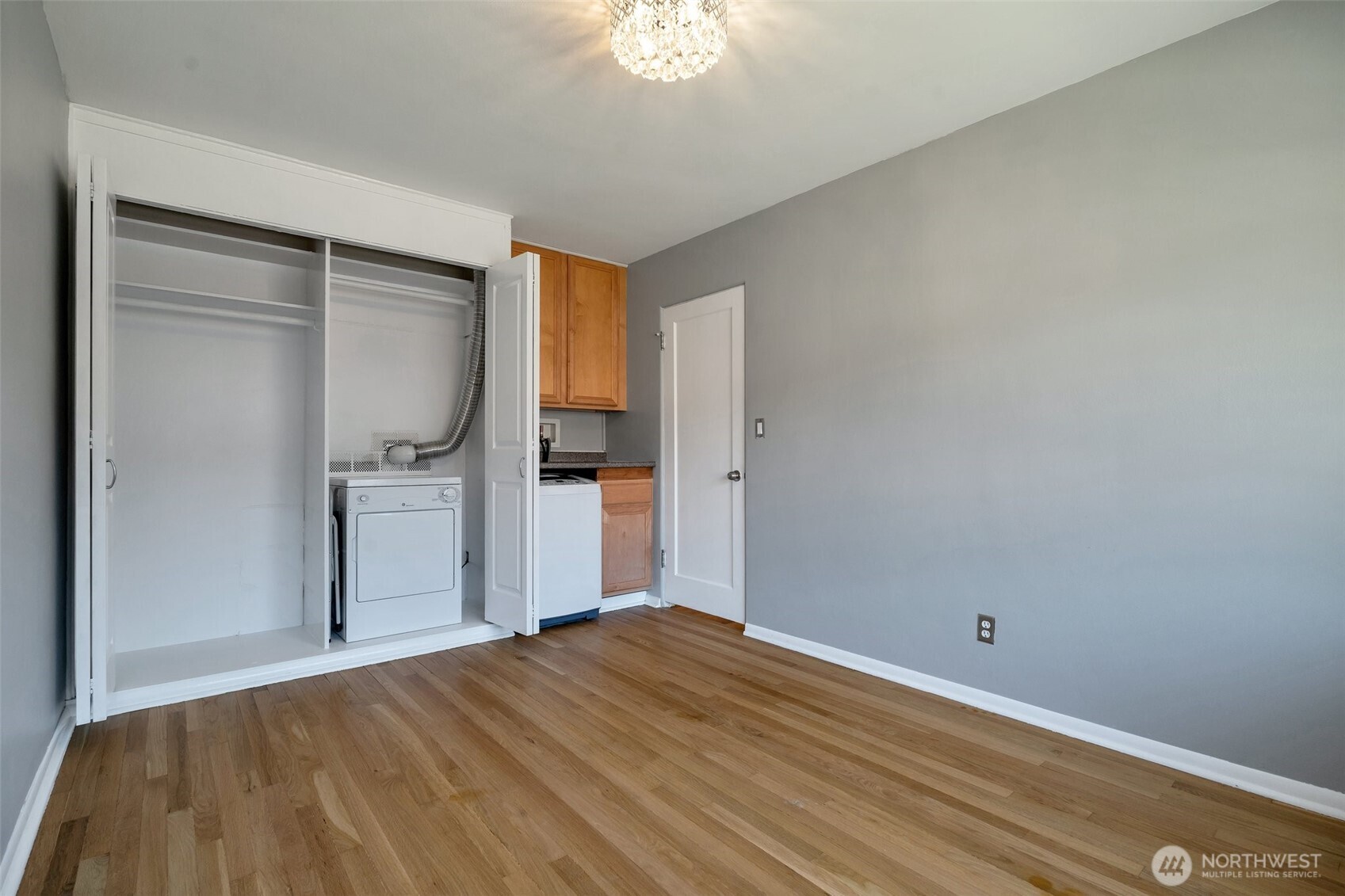 314 North G Street, Unit D2 Tacoma, WA 98403 - Photo 20 of 23 a bedroom with a bed and a chandelier