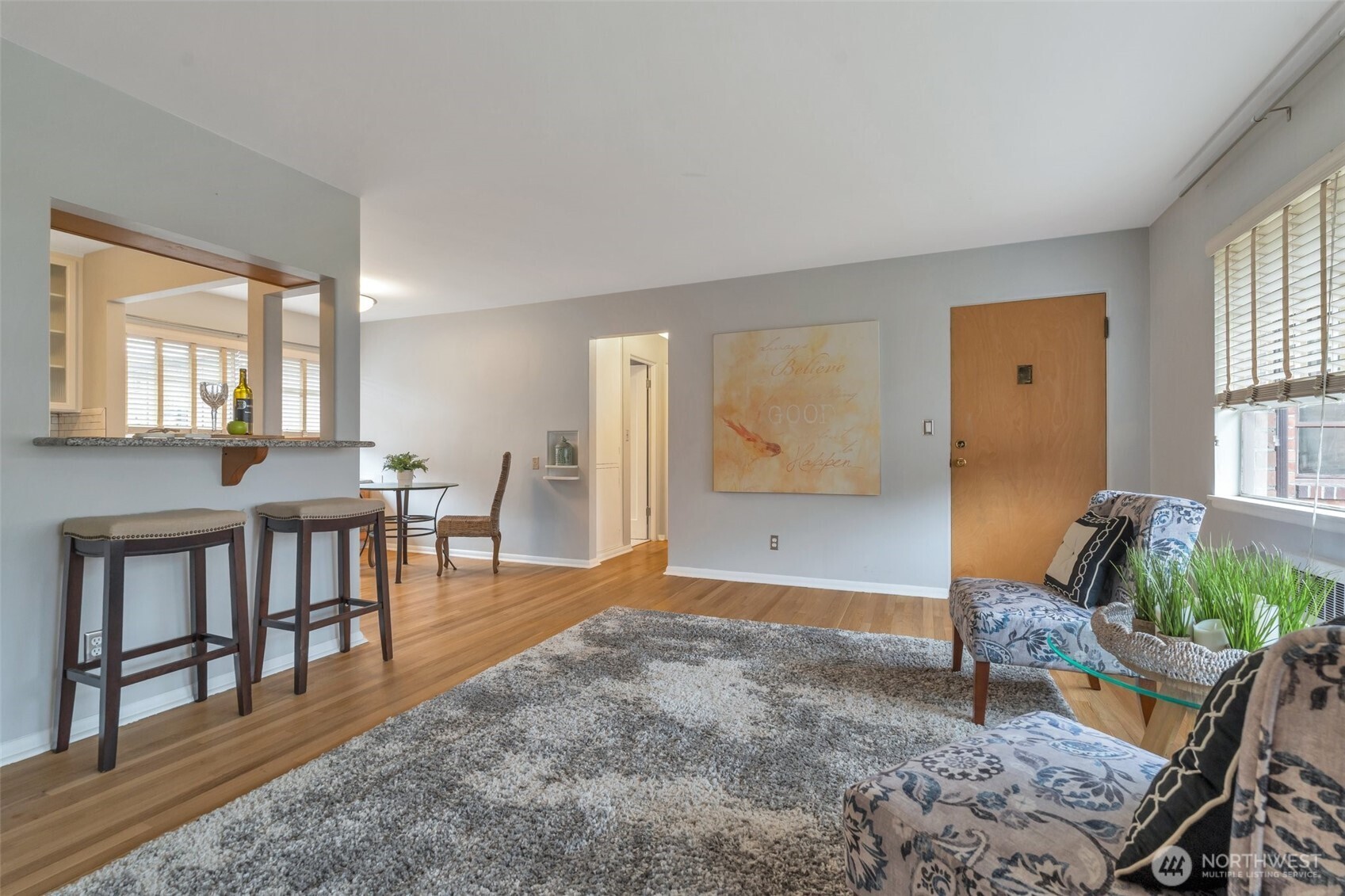 314 North G Street, Unit D2 Tacoma, WA 98403 - Photo 7 of 23 a living room with furniture a dining table and a wooden floor