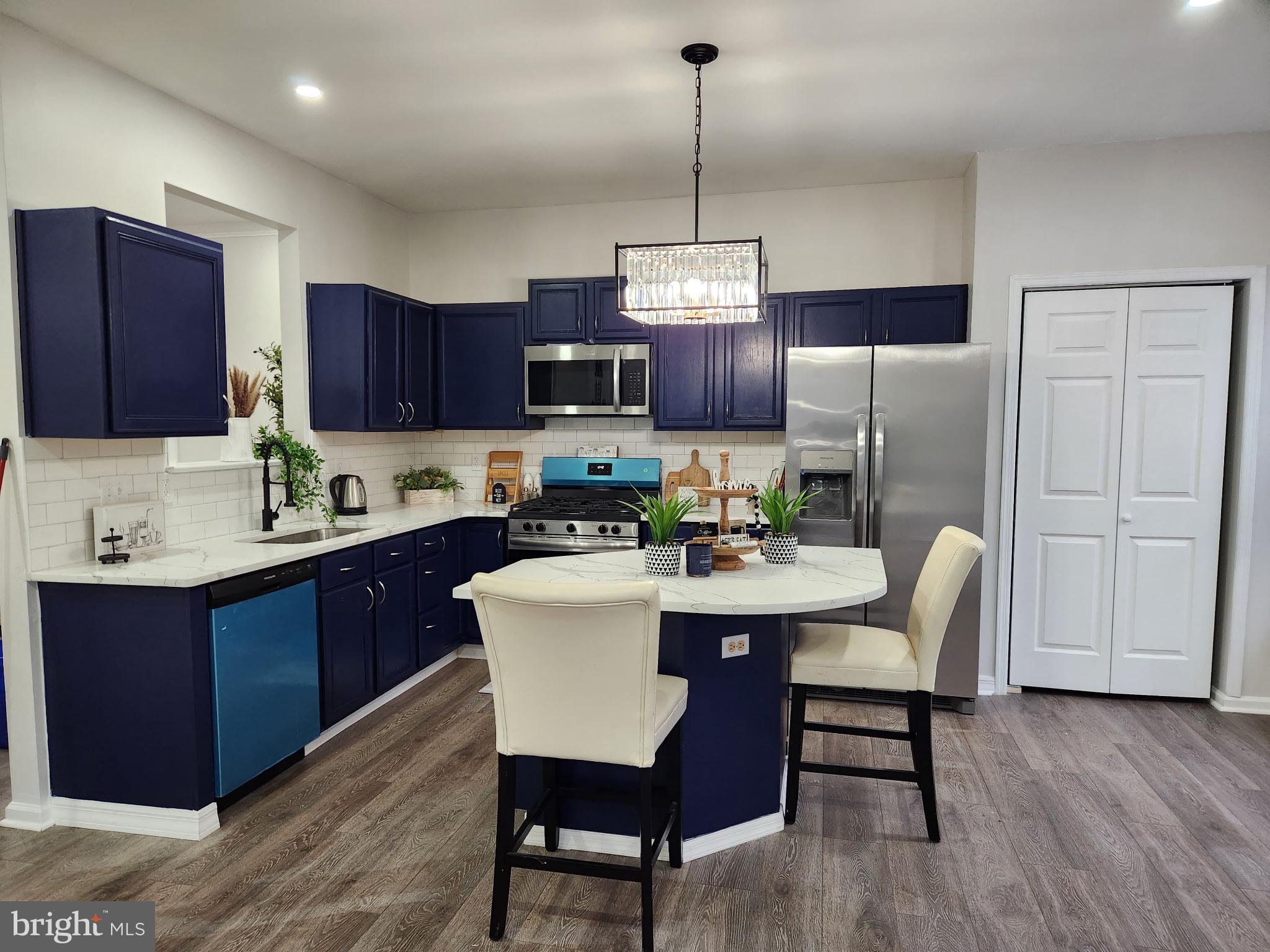 247 Becks Woods Drive Bear, DE 19701 - Photo 12 of 58 a kitchen with a dining table chairs and refrigerator