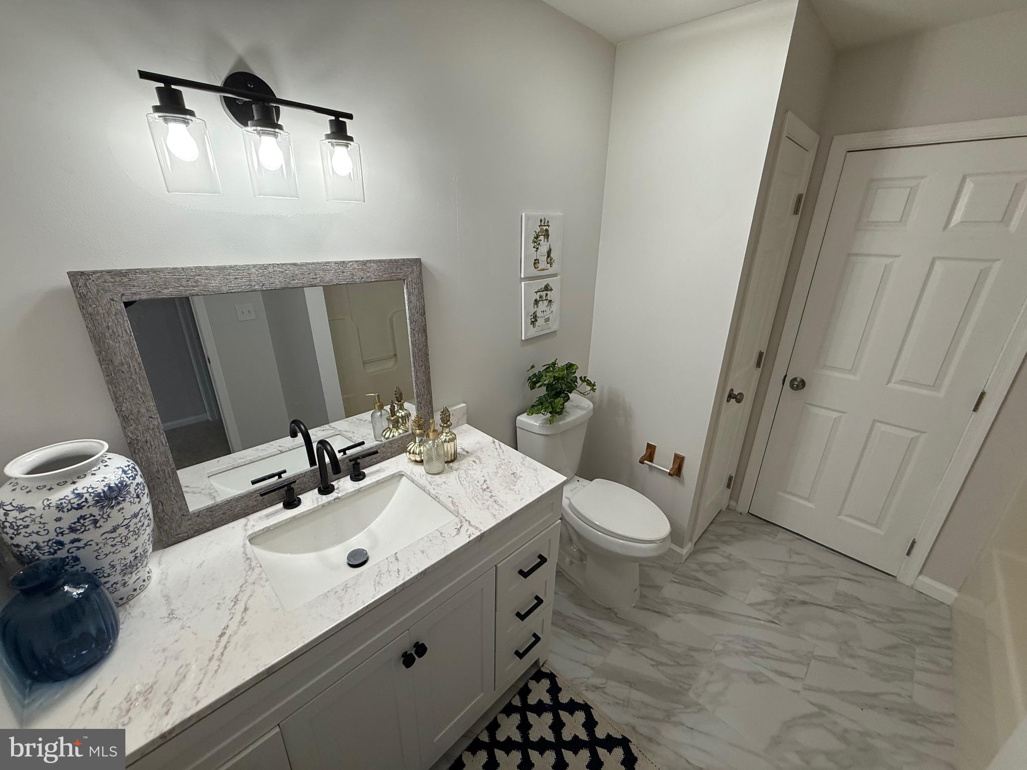 247 Becks Woods Drive Bear, DE 19701 - Photo 18 of 58 a bathroom with a double vanity sink and mirror