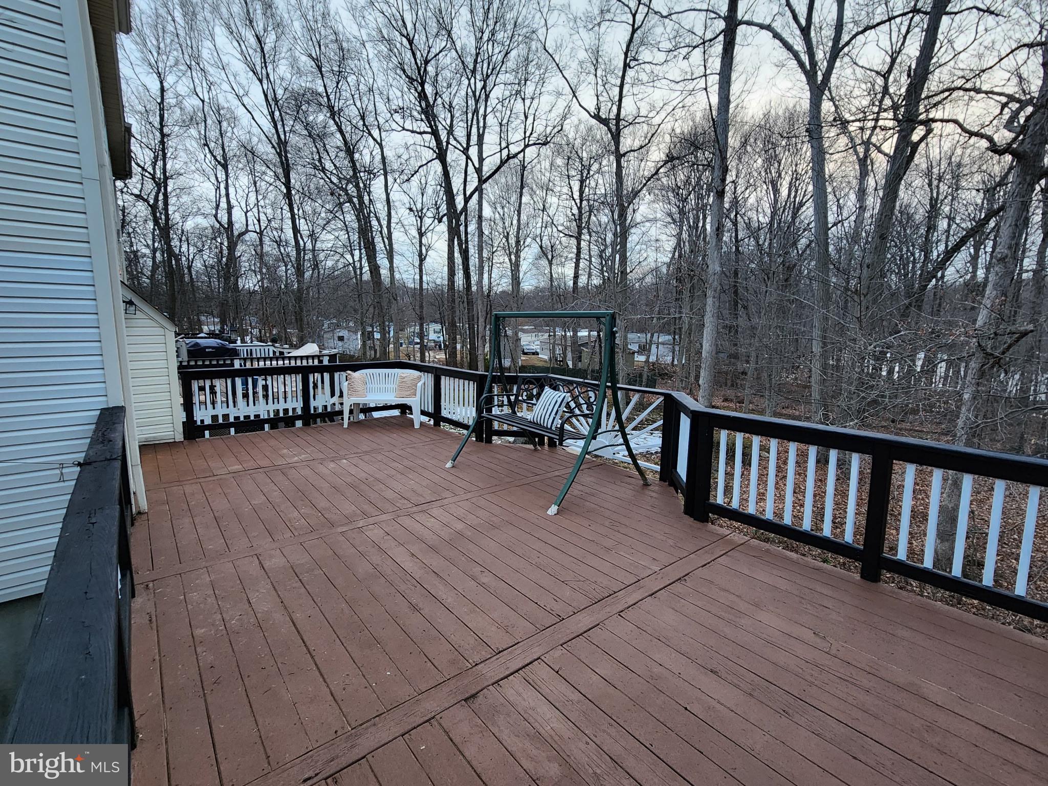 247 Becks Woods Drive Bear, DE 19701 - Photo 44 of 58 a view of a roof deck with table and chairs a barbeque with wooden floor and fence