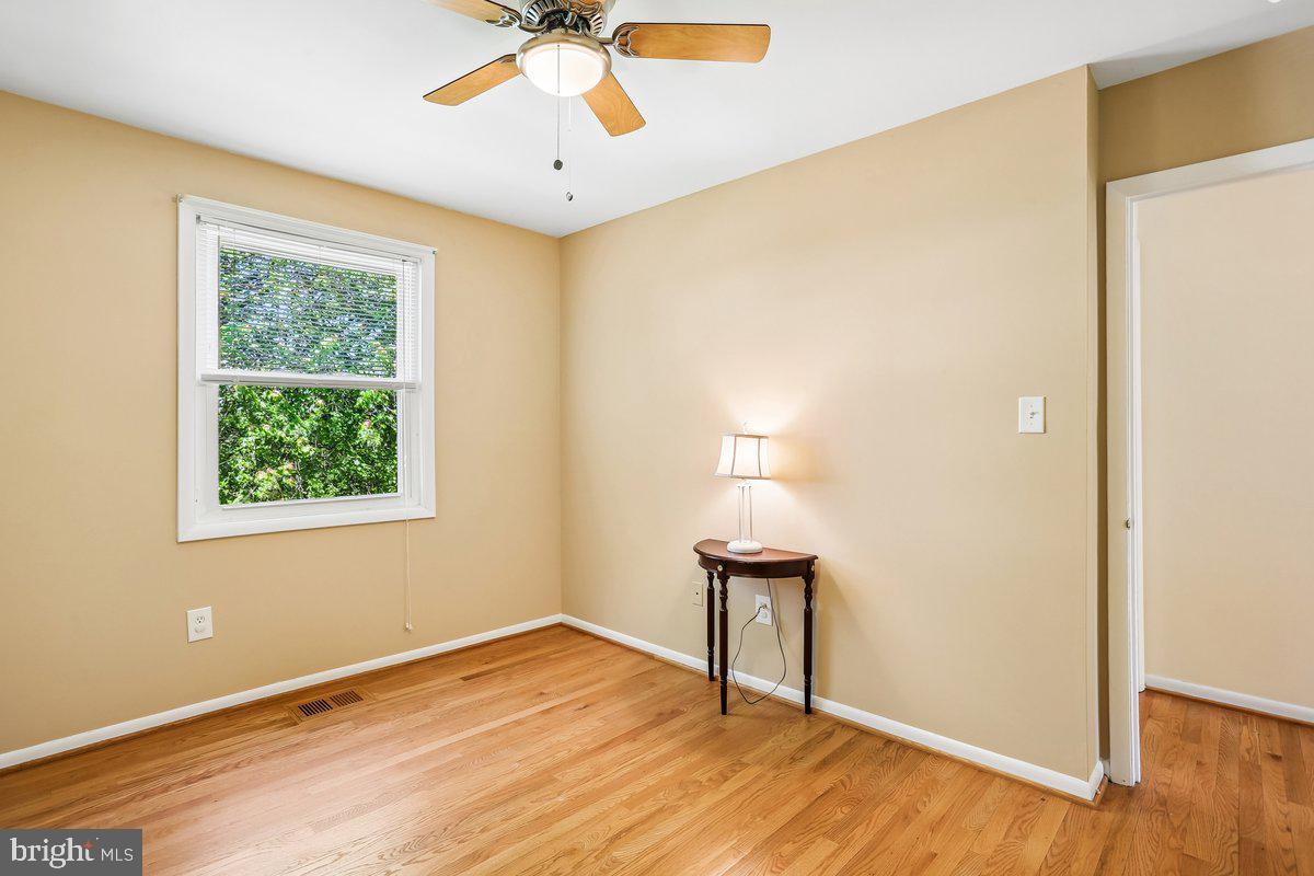 76 Timber Rock Road Gaithersburg, MD 20878 - Photo 27 of 51 a view of an empty room with wooden floor and a window