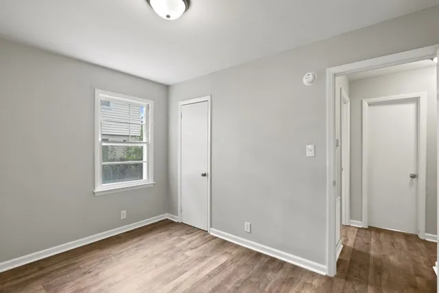 an empty room with windows and closet