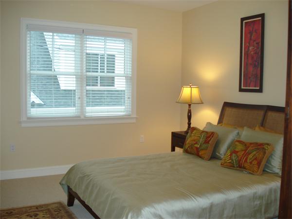 34 Courtyard Place, Unit B Lexington, MA 02420 - Photo 15 of 19 a bed sitting in a bedroom next to a window