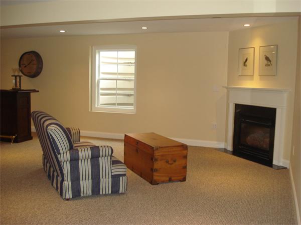 34 Courtyard Place, Unit B Lexington, MA 02420 - Photo 17 of 19 a living room with furniture and a fireplace