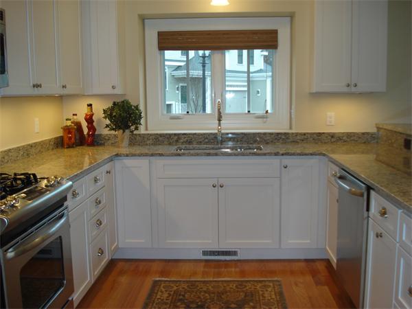34 Courtyard Place, Unit B Lexington, MA 02420 - Photo 2 of 19 a kitchen with granite countertop a sink stainless steel appliances white cabinets and a window
