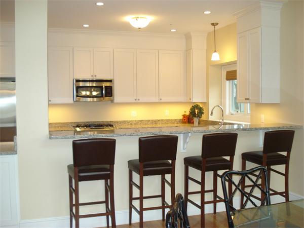 34 Courtyard Place, Unit B Lexington, MA 02420 - Photo 3 of 19 a kitchen with stainless steel appliances granite countertop a stove a sink and a microwave