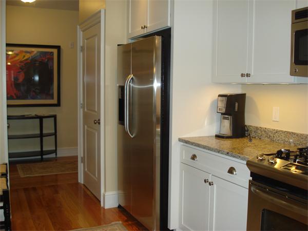 34 Courtyard Place, Unit B Lexington, MA 02420 - Photo 4 of 19 a kitchen with stainless steel appliances granite countertop a refrigerator and a stove