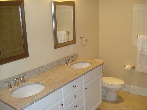 34 Courtyard Place, Unit B Lexington, MA 02420 - Photo 10 of 19 a bathroom with a granite countertop sink a toilet and a mirror