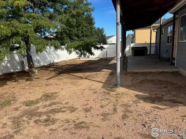 a view of a house with a wooden fence