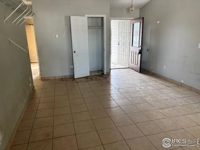a view of a livingroom with an empty space and a window