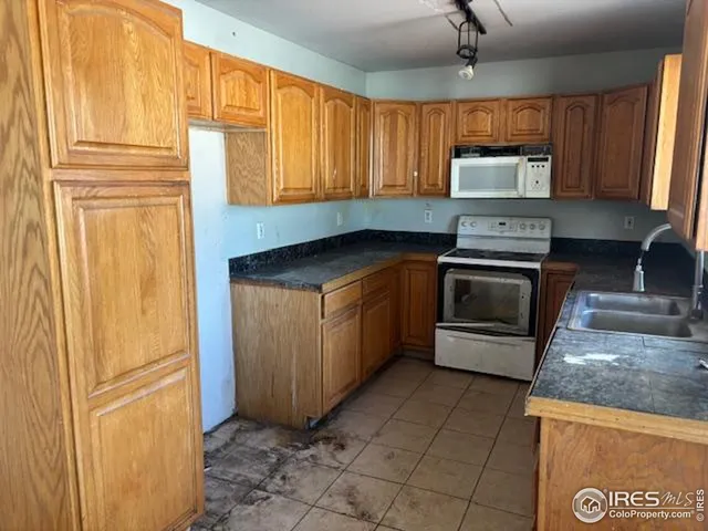 a kitchen with granite countertop cabinets stainless steel appliances and a counter space