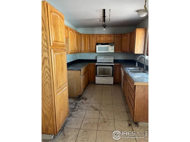 a kitchen with stainless steel appliances granite countertop a sink and cabinets