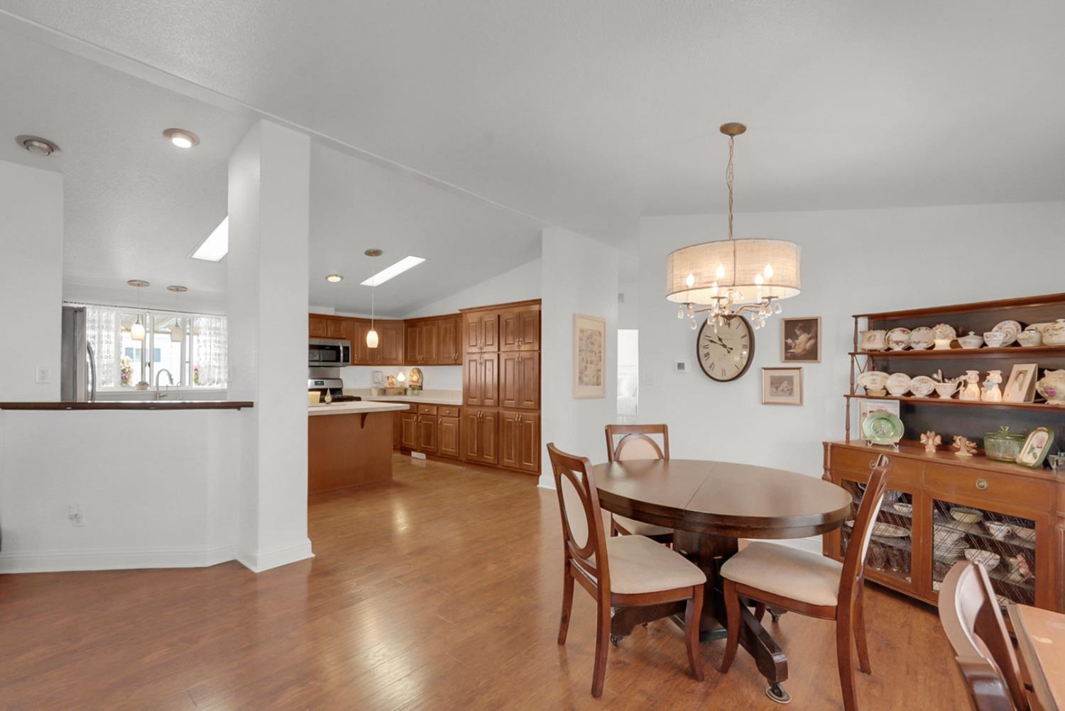1459 Standiford, Unit 92 Modesto, CA 95350 - Photo 17 of 19 a view of a dining room and livingroom with furniture wooden floor a chandelier