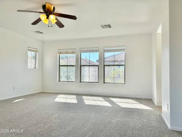 a view of empty room with ceiling fan
