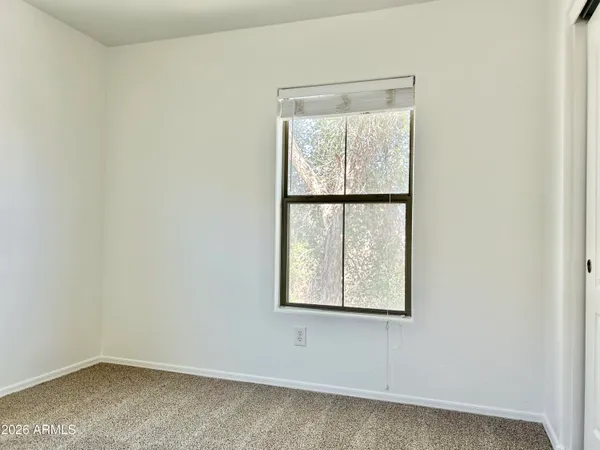 an empty room with windows and closet