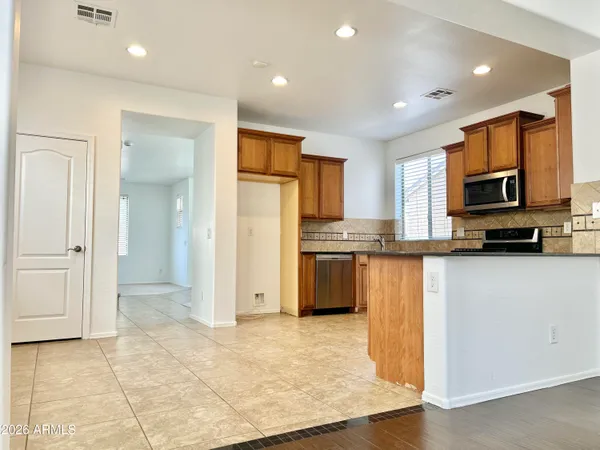 a kitchen with stainless steel appliances granite countertop a stove sink and cabinets