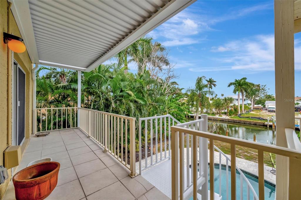 614 Norton Street Longboat Key, FL 34228 - Photo 15 of 71 a view of a chairs and table in the balcony