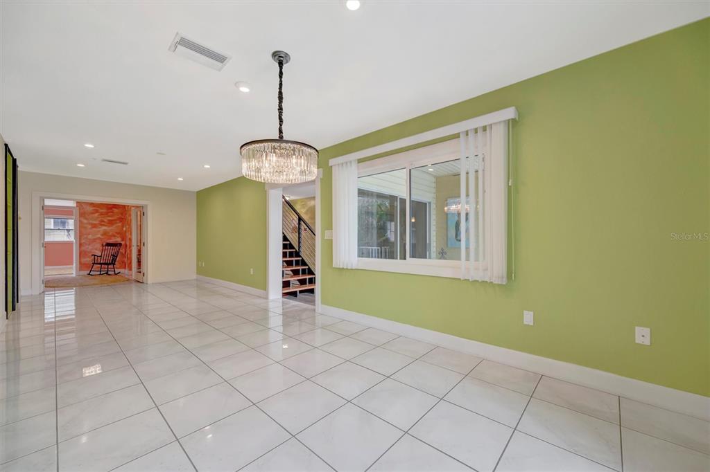614 Norton Street Longboat Key, FL 34228 - Photo 18 of 71 a view of an empty room with window and chandelier