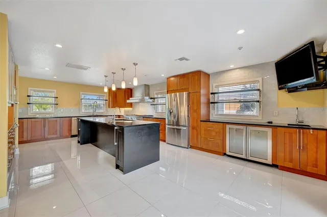 a kitchen with stainless steel appliances a sink and a refrigerator