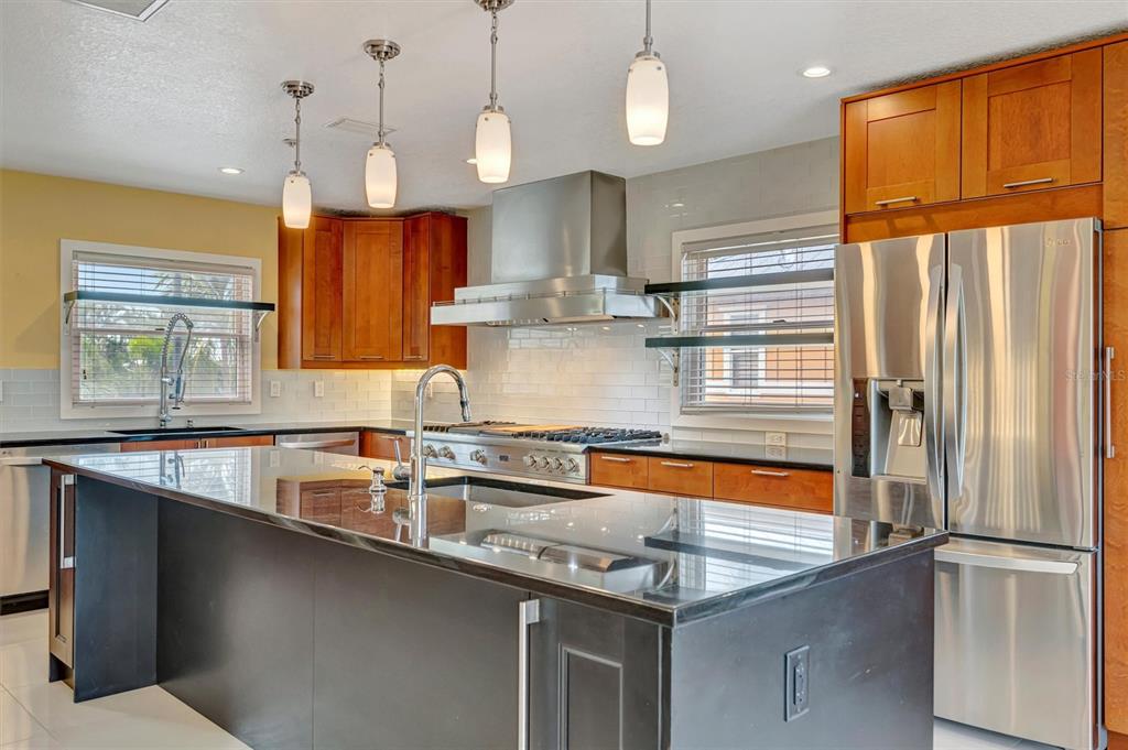 614 Norton Street Longboat Key, FL 34228 - Photo 23 of 71 a kitchen with stainless steel appliances granite countertop a sink a refrigerator and a granite counter tops