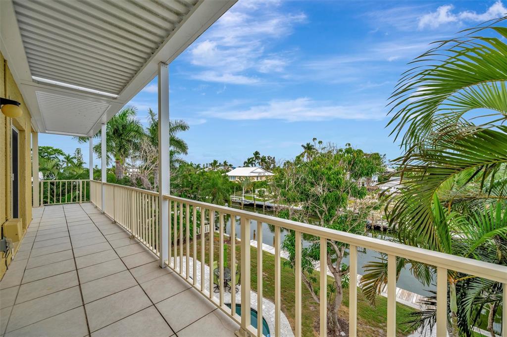 614 Norton Street Longboat Key, FL 34228 - Photo 27 of 71 a balcony with trees in front of it