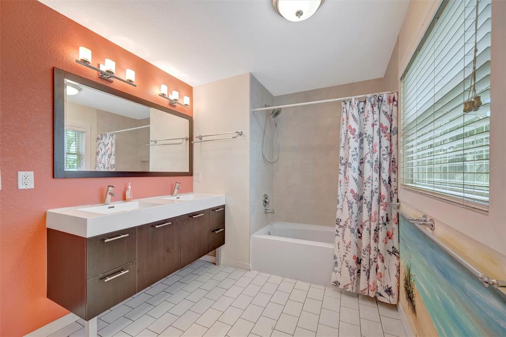 614 Norton Street Longboat Key, FL 34228 - Photo 32 of 71 a bathroom with a tub sink and mirror