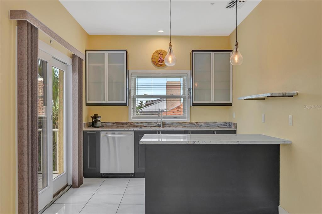 614 Norton Street Longboat Key, FL 34228 - Photo 44 of 71 a kitchen with stainless steel appliances a sink and a refrigerator