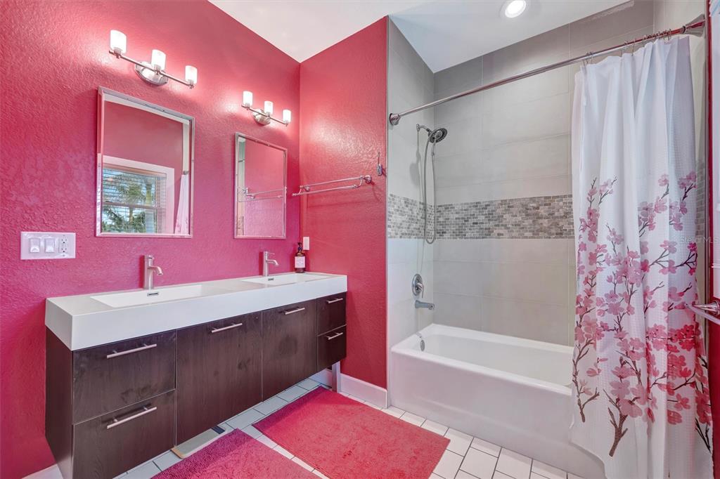 614 Norton Street Longboat Key, FL 34228 - Photo 52 of 71 a bathroom with a bathtub shower sink vanity and mirror