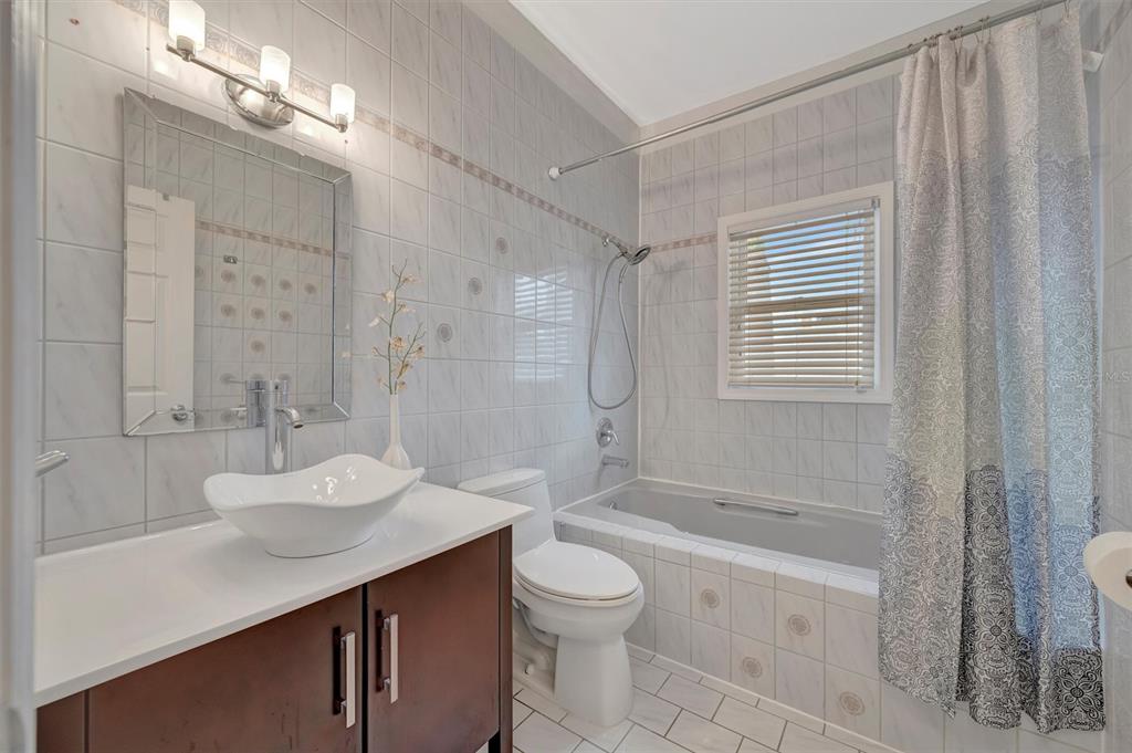 614 Norton Street Longboat Key, FL 34228 - Photo 59 of 71 a bathroom with a sink a toilet and shower