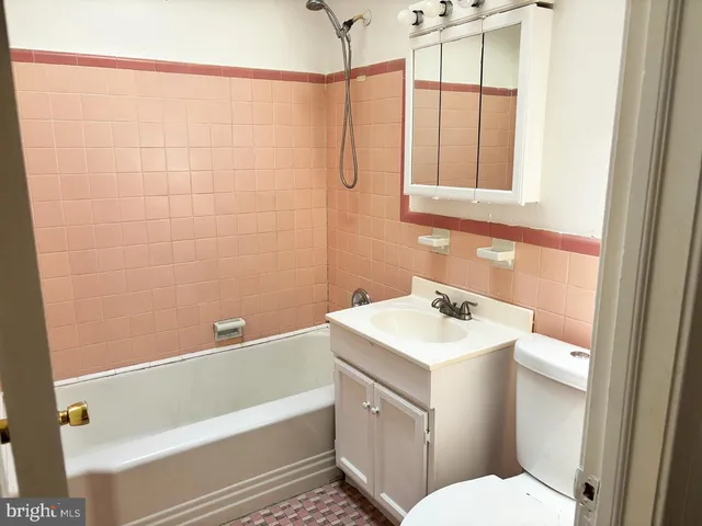 a bathroom with a sink toilet vanity and shower