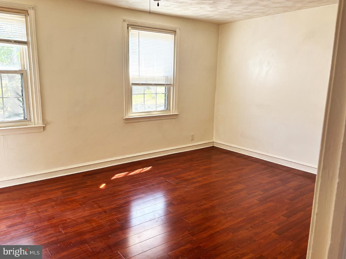 6034 Hasbrook Avenue Philadelphia, PA 19111 - Photo 7 of 14 an empty room with wooden floor and windows