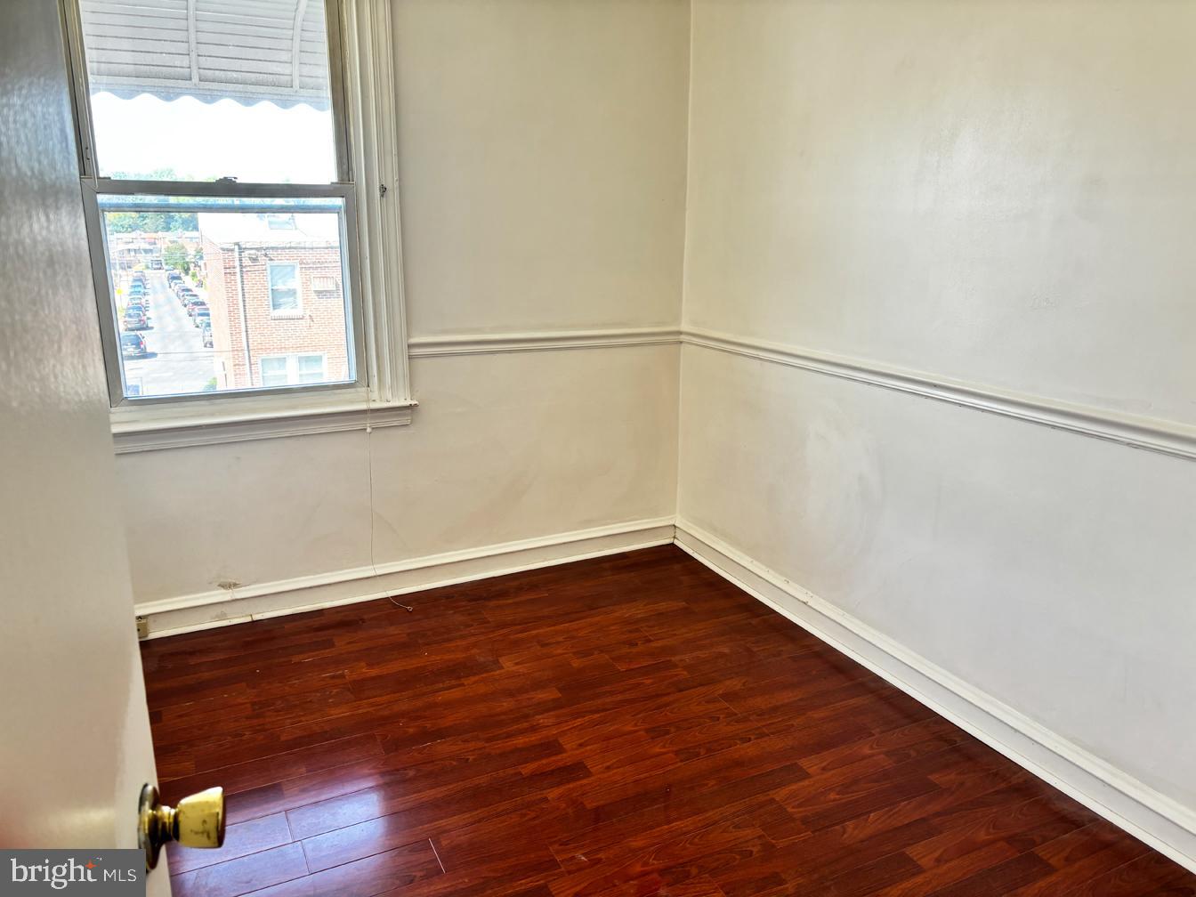 6034 Hasbrook Avenue Philadelphia, PA 19111 - Photo 10 of 14 a view of an empty room with wooden floor and a window