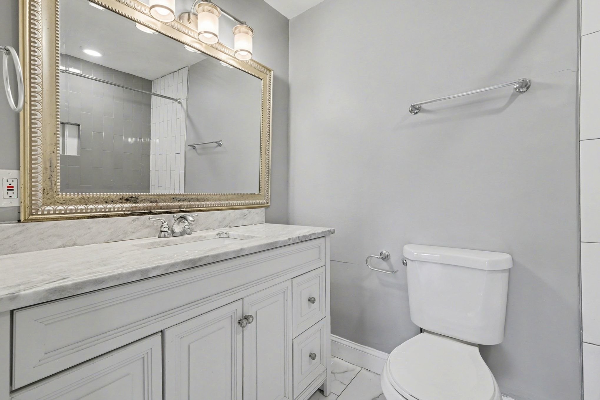 1214 Rutherford Street Murfreesboro, TN 37130 - Photo 18 of 32 a bathroom with a granite countertop toilet sink and mirror
