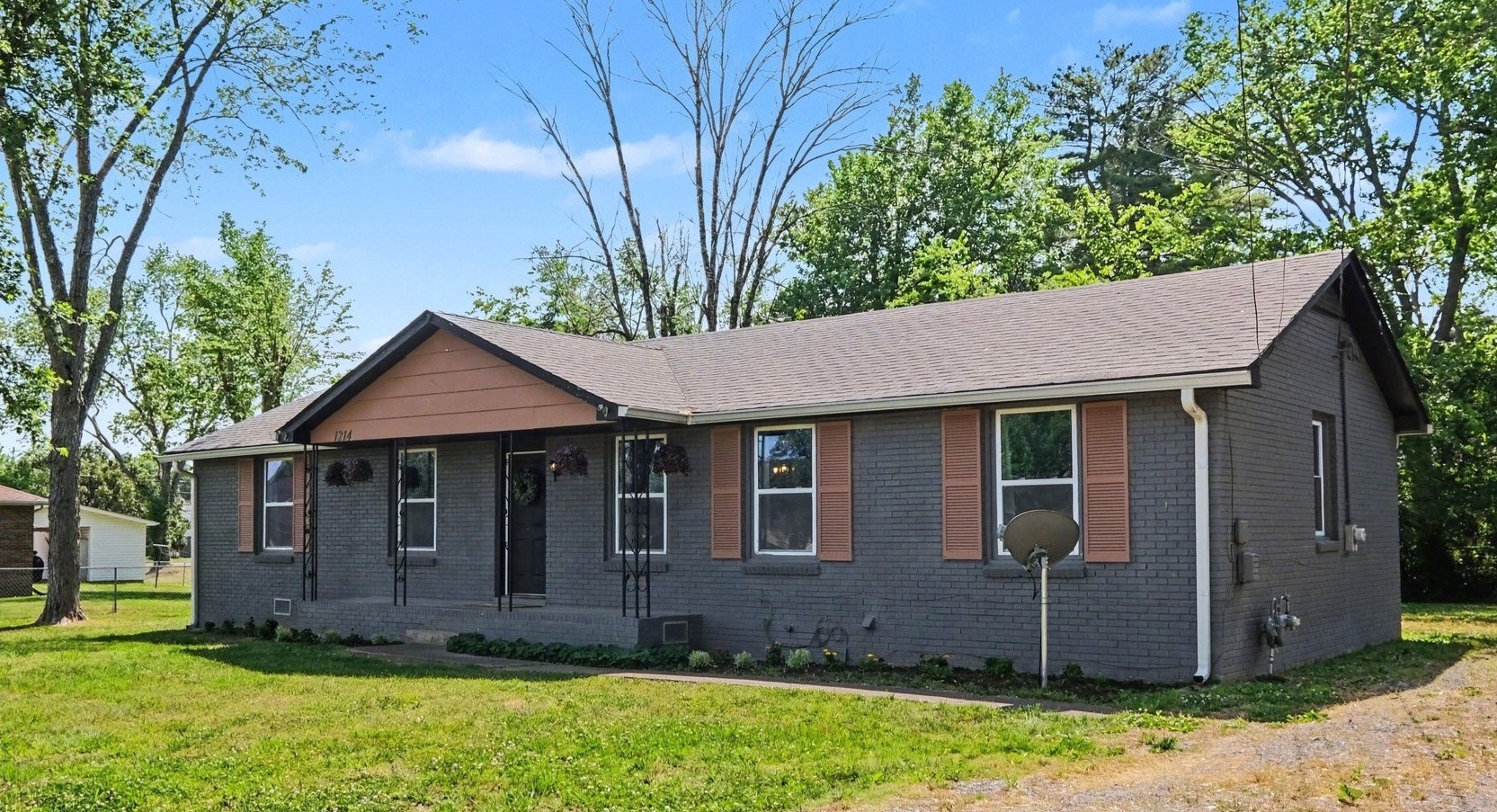 1214 Rutherford Street Murfreesboro, TN 37130 - Photo 2 of 32 a front view of a house with a garden