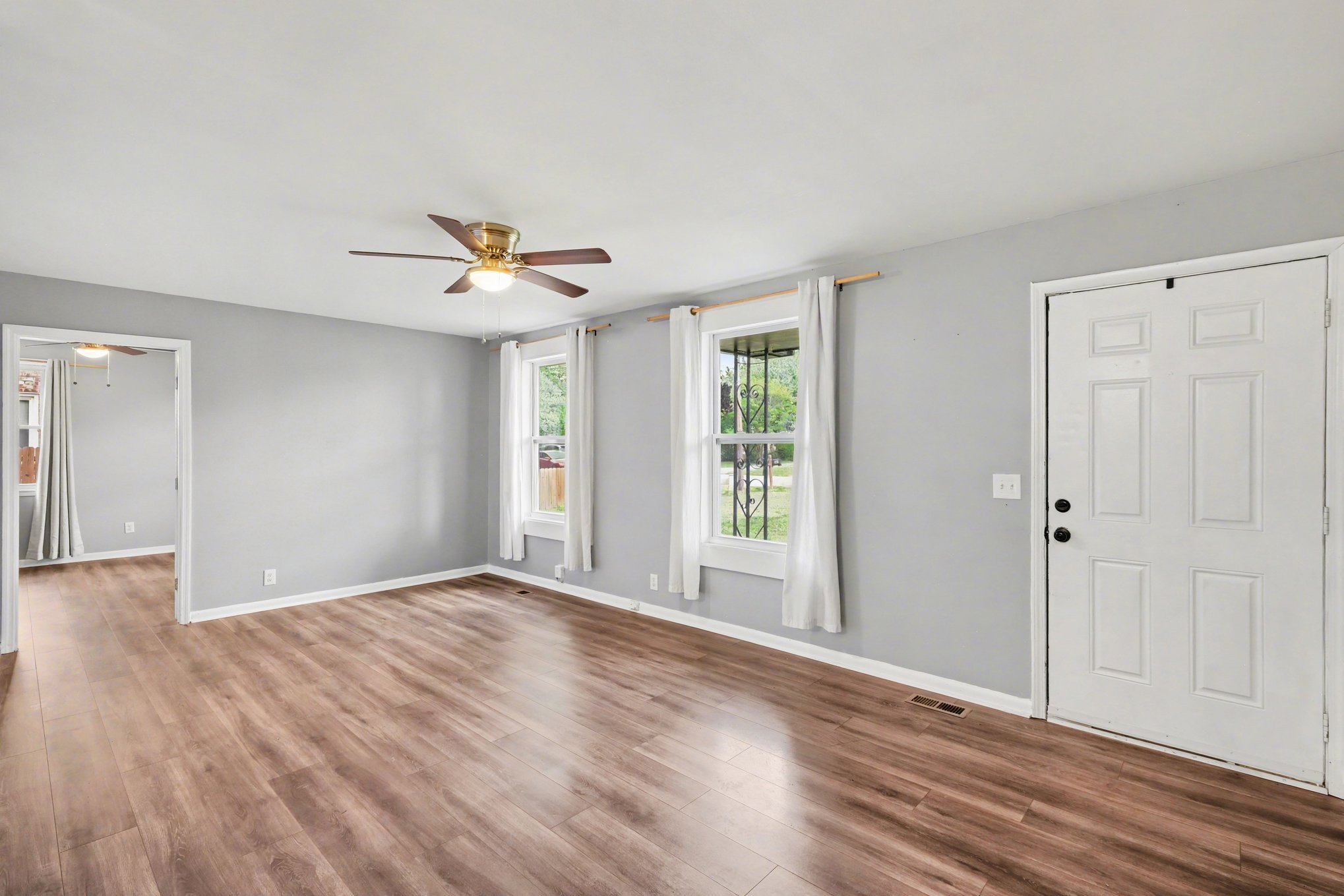 1214 Rutherford Street Murfreesboro, TN 37130 - Photo 5 of 32 a view of an empty room with a window and wooden floor