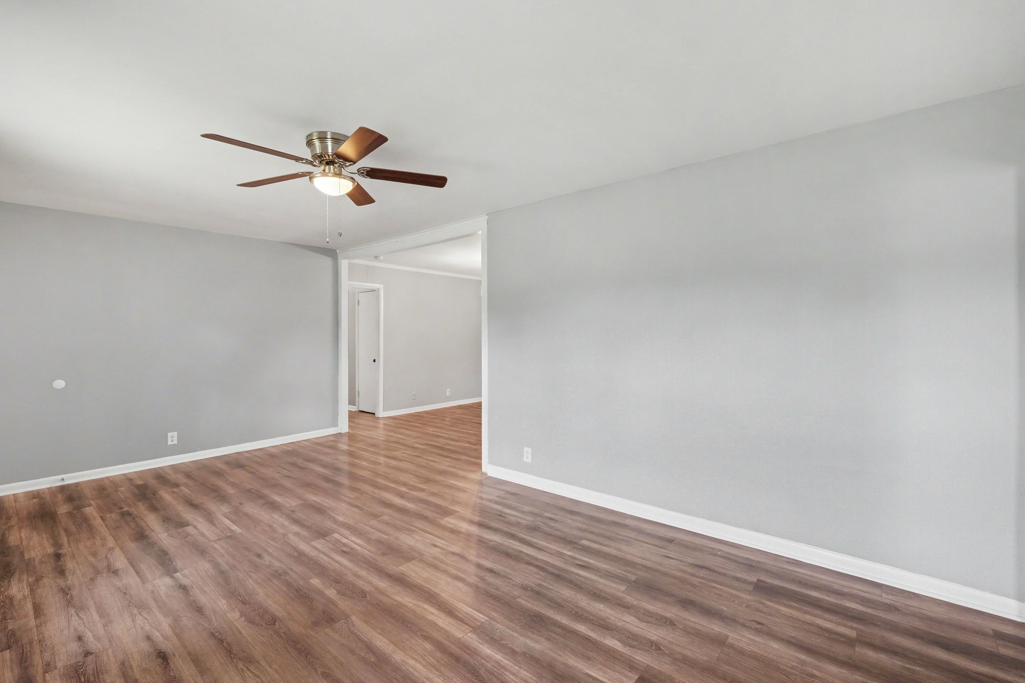 1214 Rutherford Street Murfreesboro, TN 37130 - Photo 7 of 32 a view of room with wooden floor and ceiling fan