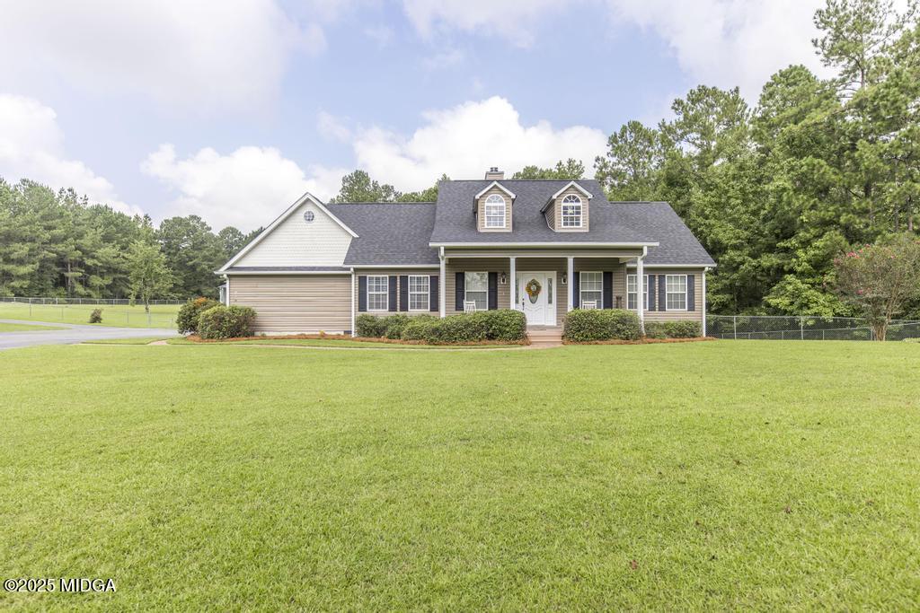 674 Mt Paran Road Lizella, GA 31052 - Photo 1 of 45 a front view of a house with a garden