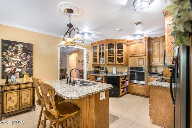 a kitchen area with granite countertop dining table and chairs