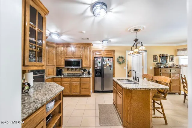 a kitchen with refrigerator and cabinets
